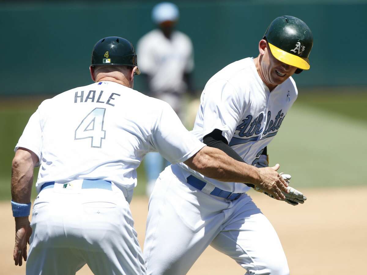 The Oakland Athletics' Ryon Healy is congratulated by third base coach Chip Hale (4) as he rounds the bases on a home run against the New York Yankees in the fourth inning at Oakland Coliseum in Oakland, Calif., on Saturday, June 17, 2017. The A's won, 5-2. (Jim Gensheimer/Bay Area News Group/TNS)