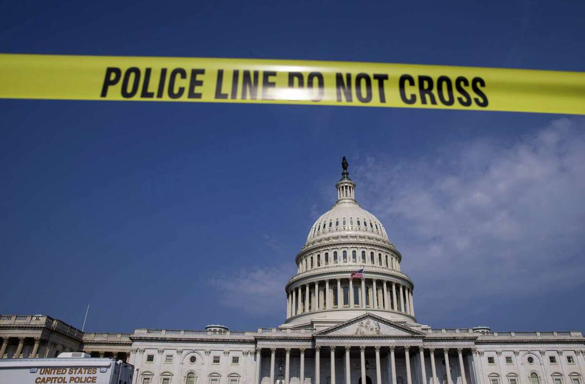 "Police Line Do Not Cross" yellow tape is seen in front of the U.S. Capitol in Washington last week. (Photo by Eric Thayer/Bloomberg)