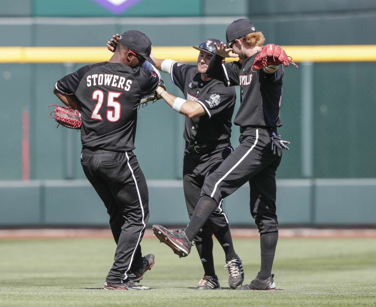 Louisville outfielders Josh Stowers (25), Logan Taylor, center, and Colin Lyman, right, celebrate at the end of an NCAA College World Series baseball game against Texas A&M in Omaha, Neb., Sunday, June 18, 2017. Louisville won 8-4. (AP Photo/Nati Harnik)