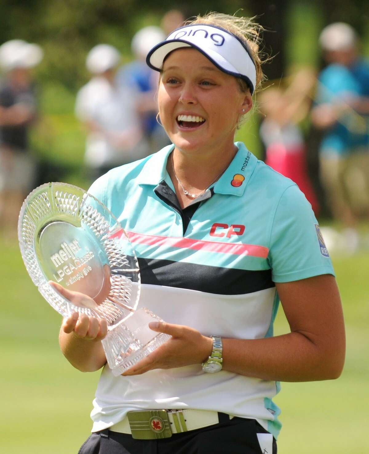Brooke Henderson, of Canada, holds the trophy after winning the Meijer LPGA Classic golf tournament at Blythefield Country Club. Sunday, June 18, 2017, in Grand Rapids, Mich.. (Cory Olsen/The Grand Rapids Press via AP)