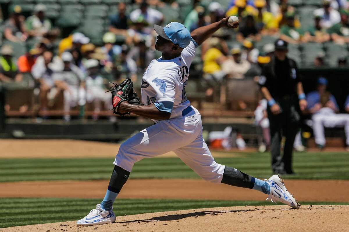 Oakland Athletics pitcher Jharel Cotton throws against the New York Yankees during a baseball game between the Oakland Athletics and New York Yankees at Oakland Alameda Coliseum in Oakland, California, on Sunday, June 18, 2017.