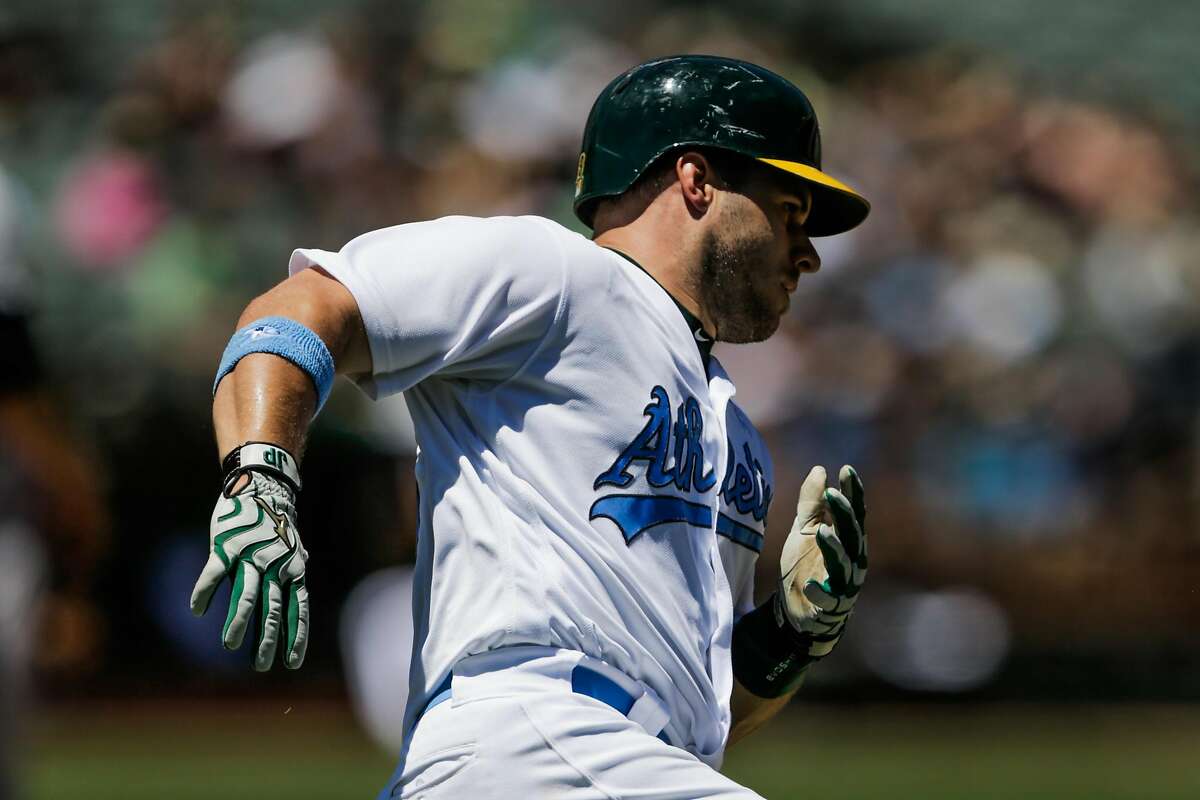 Oakland Athletics Josh Phegley (19) runs to first base during a game between the Oakland Athletics and New York Yankees at Oakland Alameda Coliseum in Oakland, California, on Sunday, June 18, 2017.