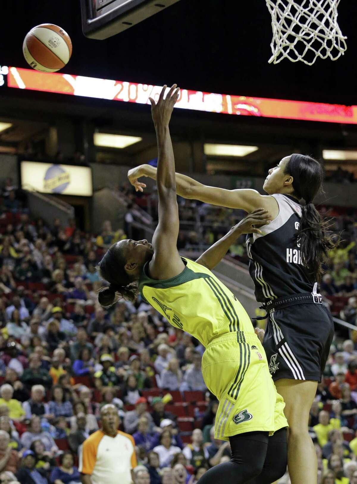 San Antonio Stars' Isabelle Harrison, right, blocks a shot by Seattle Storm's Jewell Loyd in the first half of a WNBA basketball game Sunday, June 18, 2017, in Seattle. (AP Photo/Elaine Thompson)