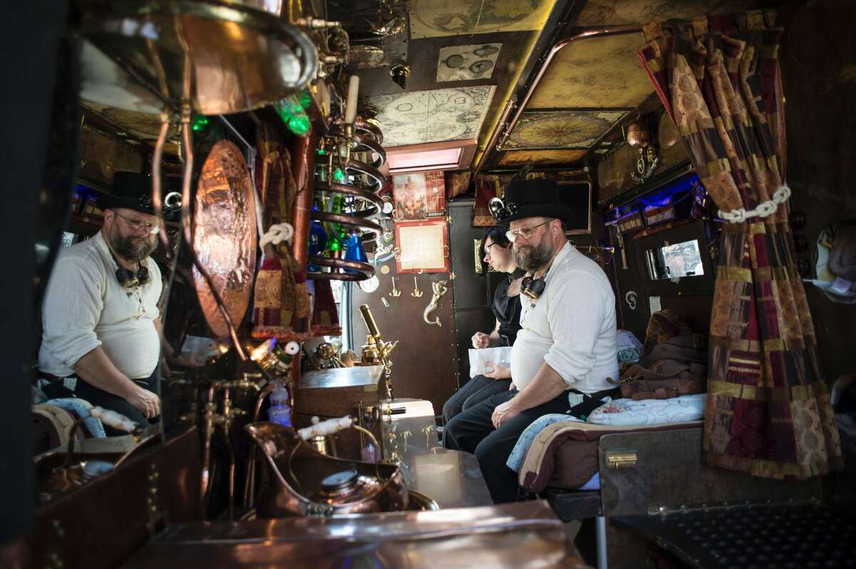 Steampunk enthusiasts sit in their customised motorhome as they attend the first day of 'The Asylum Steampunk Festival' in Lincoln, northern England on August 26, 2016. The four-day alternative lifestyle festival is the largest and longest running steampunk festival in the World; combining art, literature, music, fashion and comedy. Steampunk is a subgenre of science fiction or science fantasy that incorporates technology and aesthetic designs inspired by 19th-century industrial steam-powered machinery.