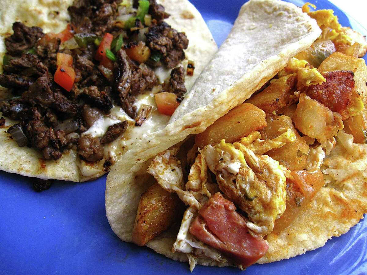 Enrique's Taco, left, with grilled steak, queso blanco and pico de gallo on a handmade flour tortilla and a Cowboy taco with country sausage, potatoes, eggs and salsa ranchera on handmade corn from Taco Riendo.