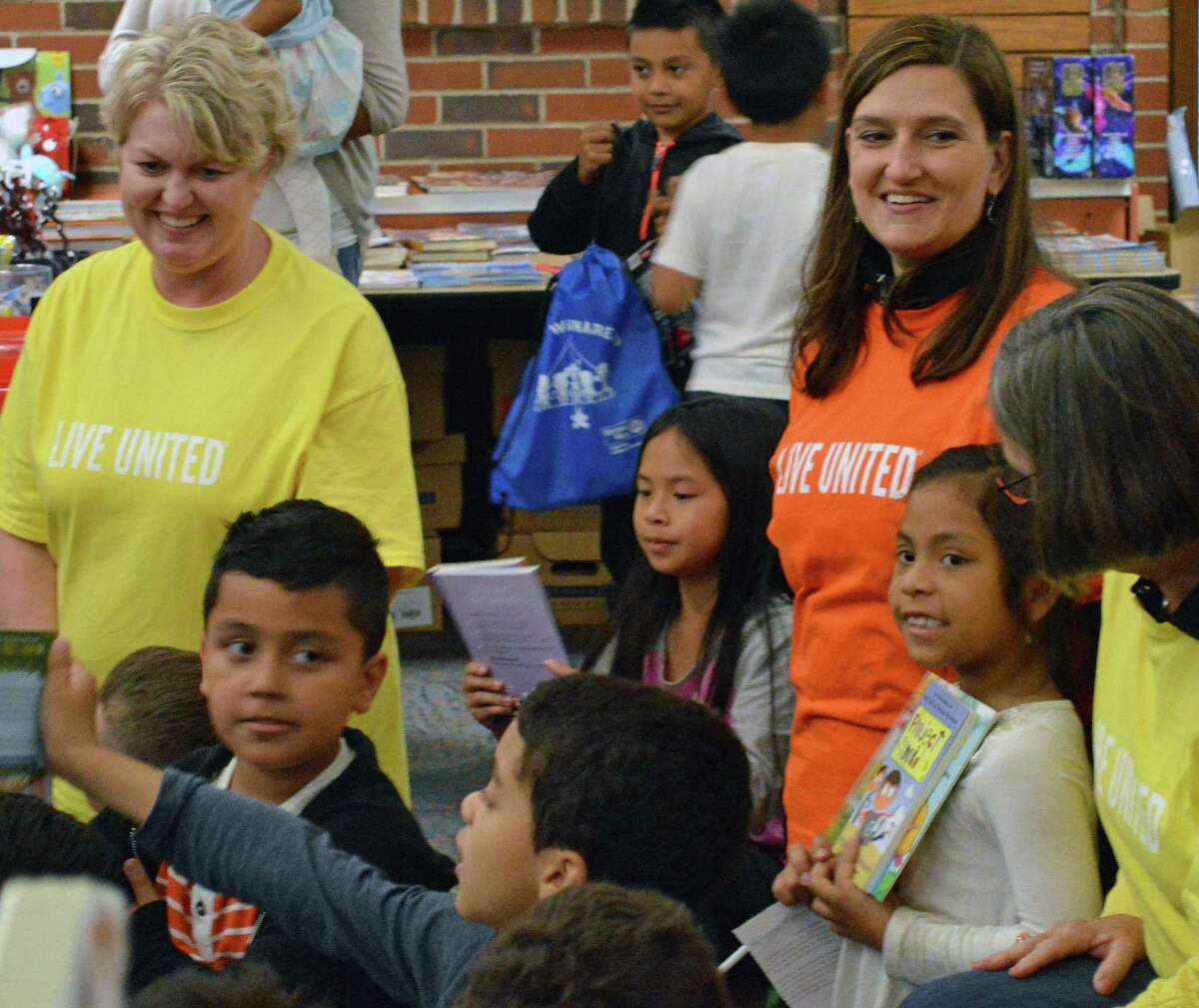 United Way CEO Kimberly Morgan, left, United Way Executive Vice President Isabel Almeida, and Cindy Merkle, president and CEO of Union Savings Bank and chair of United Way’s board of directors, help deliver drawstring backpacks to second graders at South Street School as part of United Way’s Day of Action on June 6.
