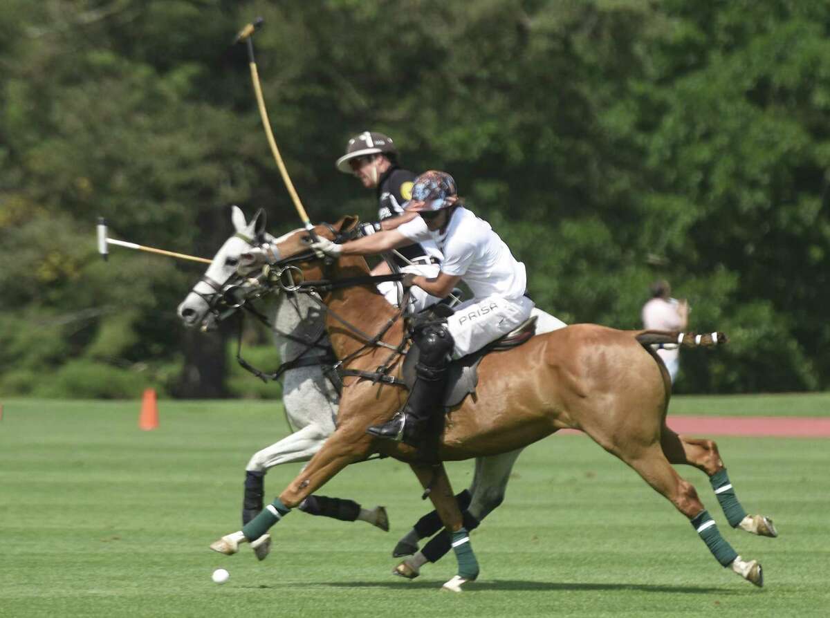 Cavalleria Toscana's Mike Davis, right, rides alongside Work to Ride's Joseph Manheim in the Monty Waterbury Cup tournament game between Work To Ride and Cavalleria Toscana at Greenwich Polo Club in Greenwich, Conn. Sunday, June 18, 2017. Work to Ride came from behind to defeat Cavalleria Toscana 13-12. The tournament will continue June 25 with the 20-goal USPA Monty Waterbury Cup final.