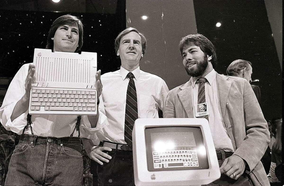 In April 1984 Apple Chairman Steve Jobs, from left, President John Sculley and Apple co-founder Steve Wozniak unveil the new Apple IIc computer in San Francisco. 