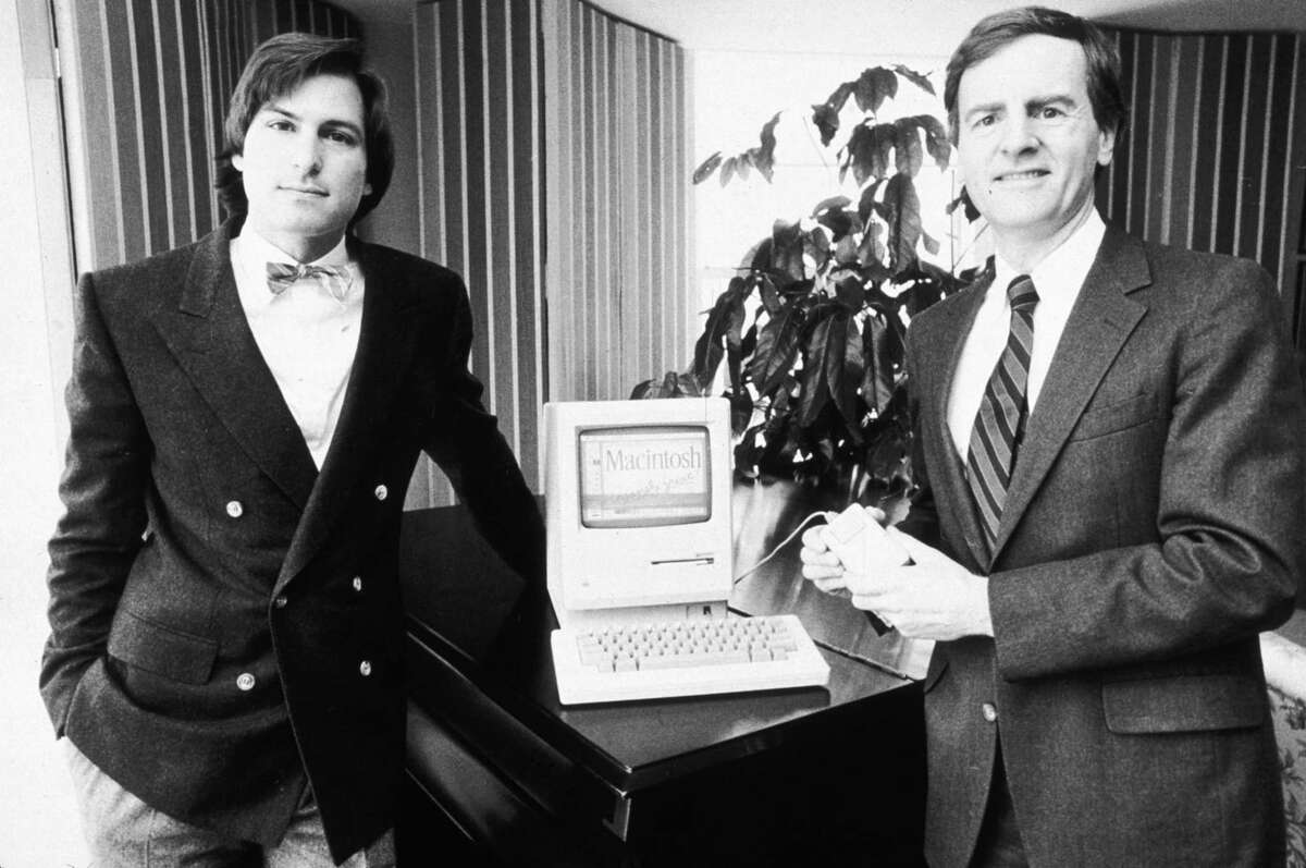 Apple's Steve Jobs and John Sculley show off the new Macintosh computer in 1984.