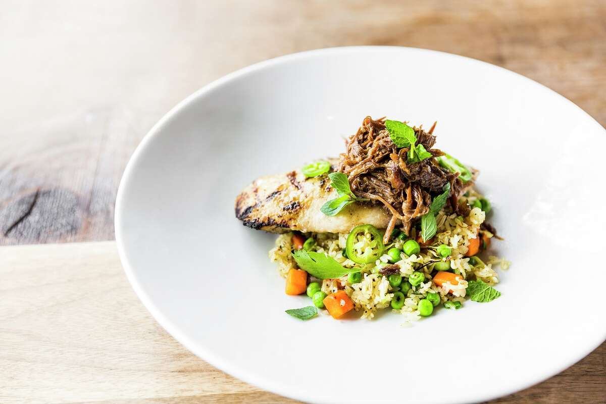 Grilled Gulf fish with braised oxtail and fried rice from the new fish- and vegetable-focused menu at Underbelly.