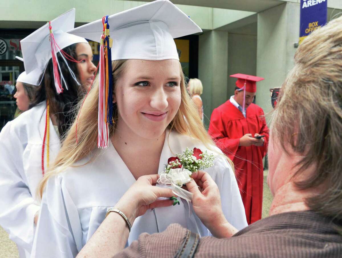 Gwen Sofka has a corsage pinned on her gown by her mother Carla Sofka before graduation ceremonies for Guilderland High School at SEFCU Arena Saturday June 27, 2015 in Albany, NY. (John Carl D'Annibale / Times Union)