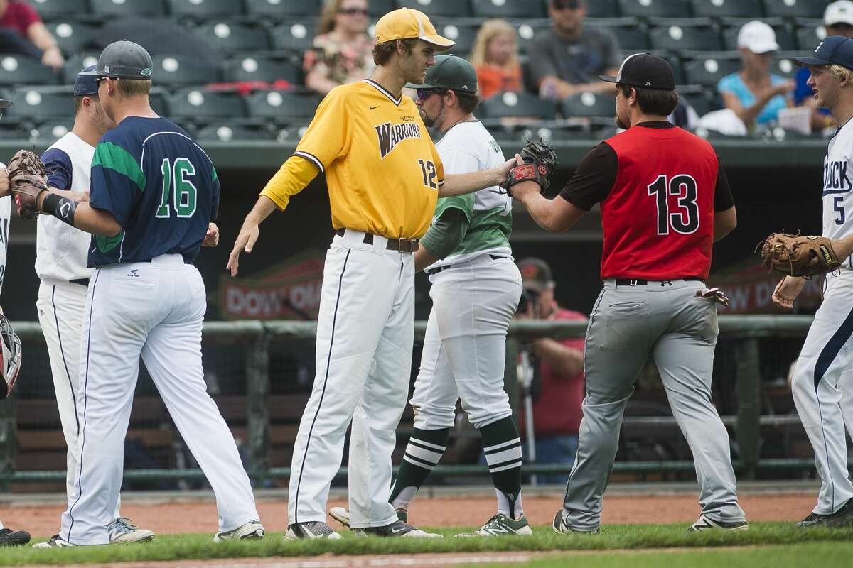 Bay City Western senior Cody Freed (12) high fives his teammates during the 3rd Annual North vs. South All Star Baseball Game on Monday, June 19, 2017 at Dow Diamond.