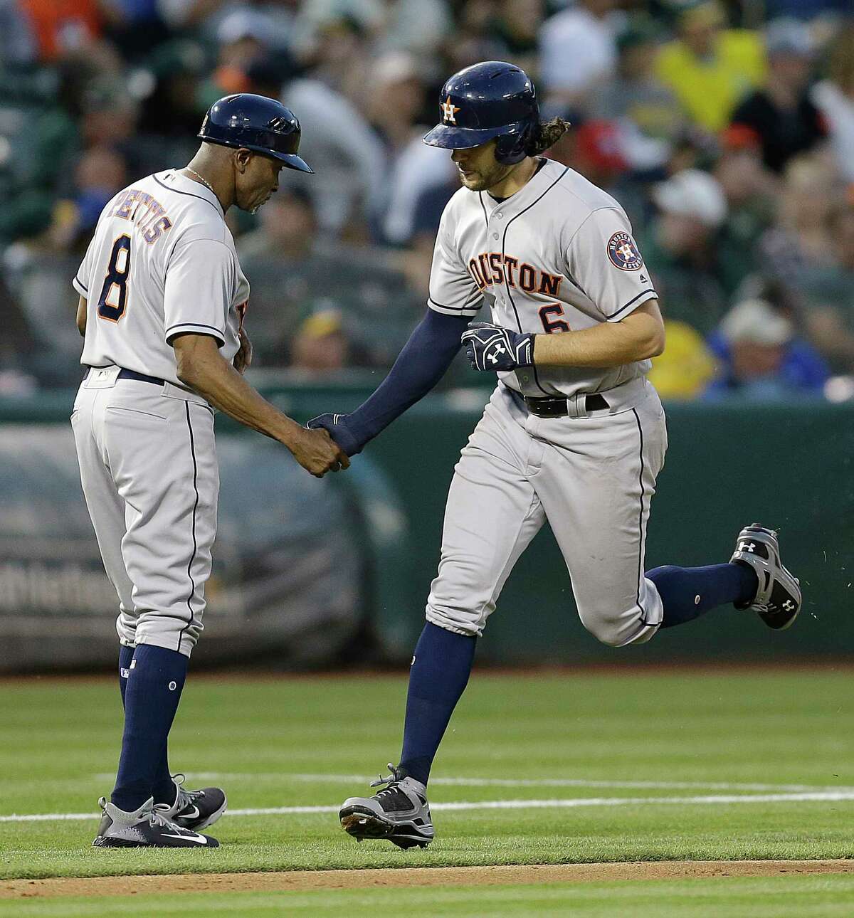 Houston Astros' Jake Marisnick, right, celebrates with third base coach Gary Pettis (8) after hitting a two run home run off Oakland Athletics' Daniel Gossett in the fifth inning of a baseball game Monday, June 19, 2017, in Oakland, Calif. (AP Photo/Ben Margot)