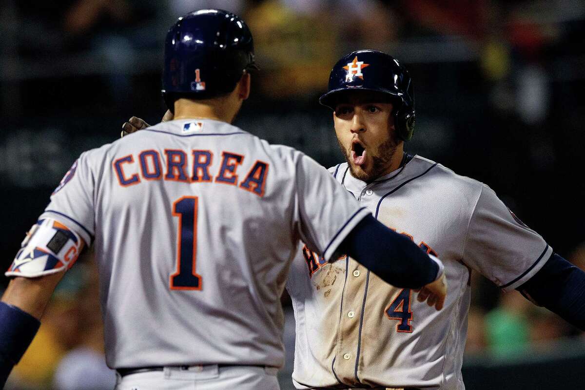 OAKLAND, CA - JUNE 19: George Springer #4 of the Houston Astros is congratulated by Carlos Correa #1 after hitting a home run against the Oakland Athletics during the eighth inning at the Oakland Coliseum on June 19, 2017 in Oakland, California. The Houston Astros defeated the Oakland Athletics 4-1.