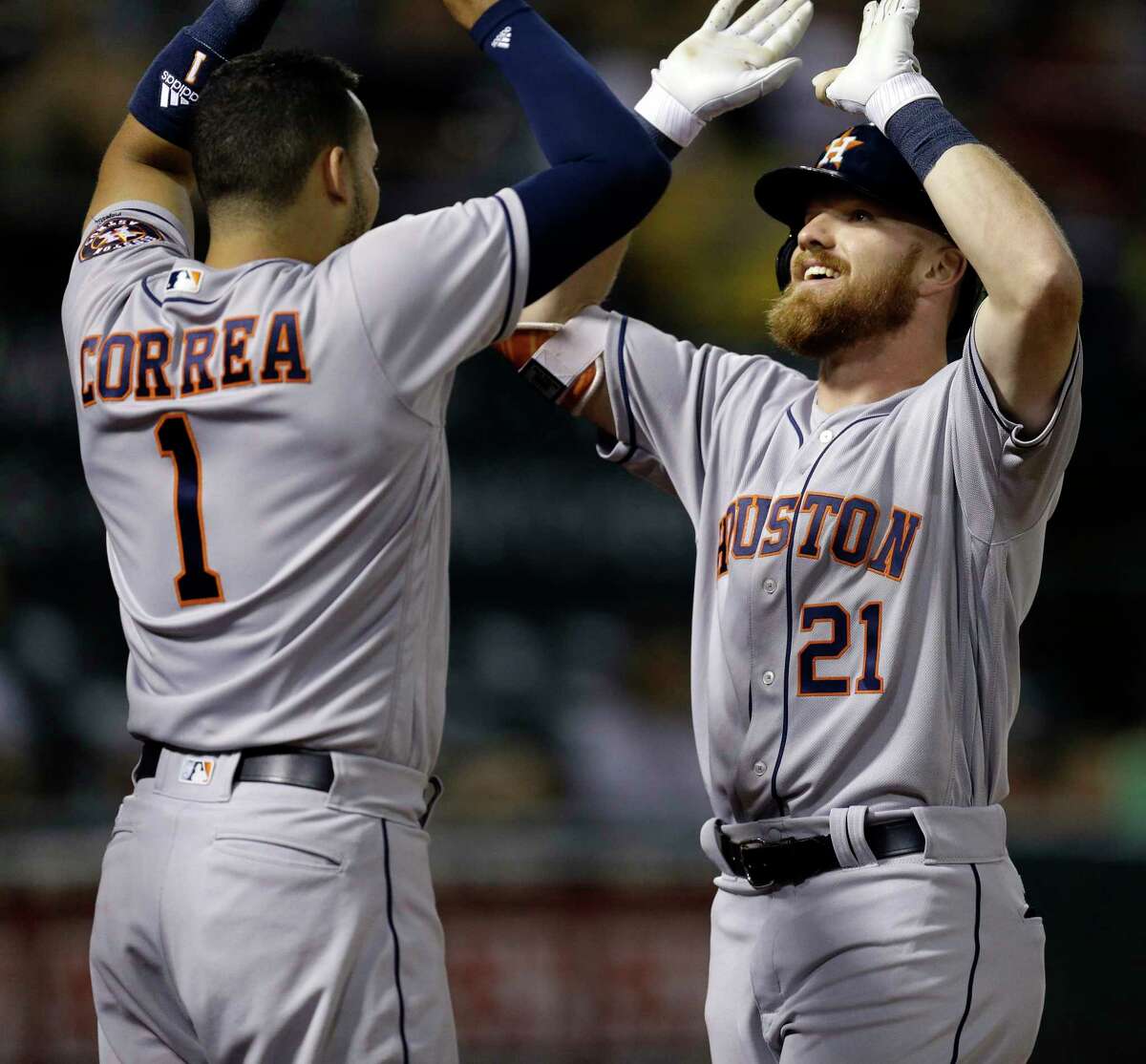 Houston Astros' Derek Fisher right, celebrates with Carlos Correa (1) after hitting a home run off Oakland Athletics' Josh Smith in the ninth inning of a baseball game Monday, June 19, 2017, in Oakland, Calif. (AP Photo/Ben Margot)