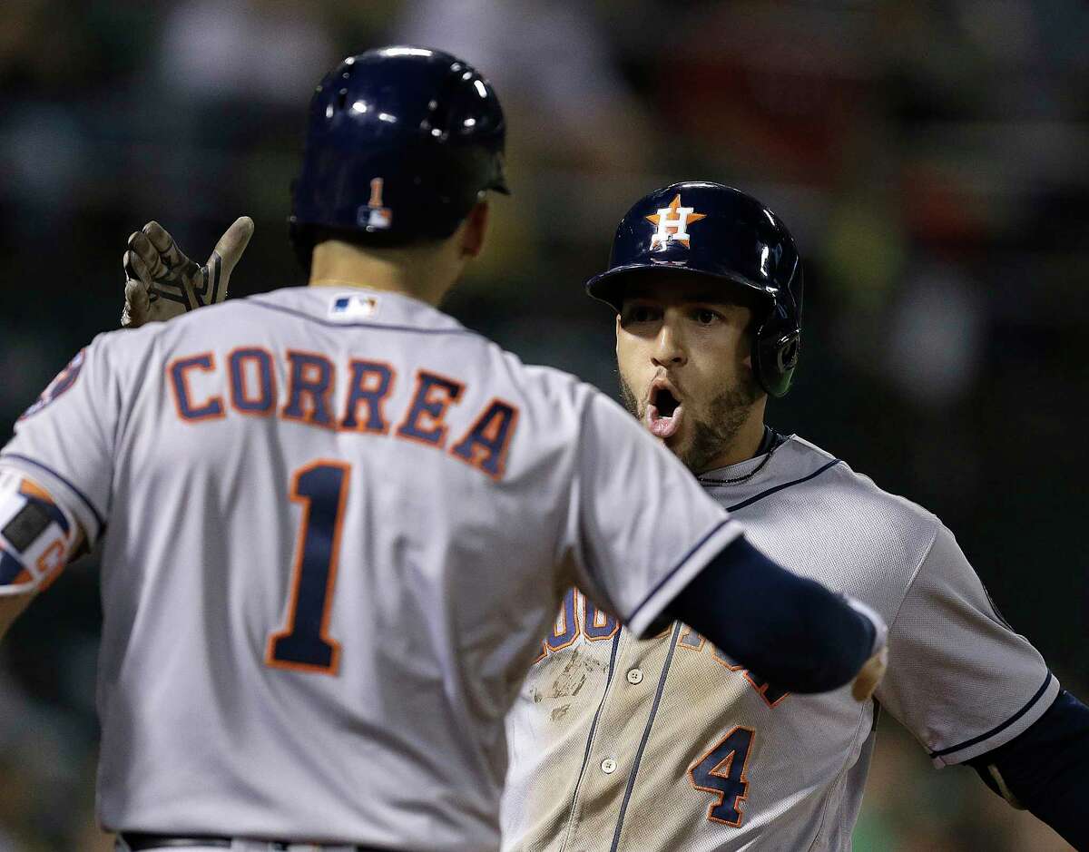 Houston Astros' George Springer, right, celebrates with Carlos Correa (1) after hitting a home run off Oakland Athletics' John Axford in the eighth inning of a baseball game Monday, June 19, 2017, in Oakland, Calif. (AP Photo/Ben Margot)