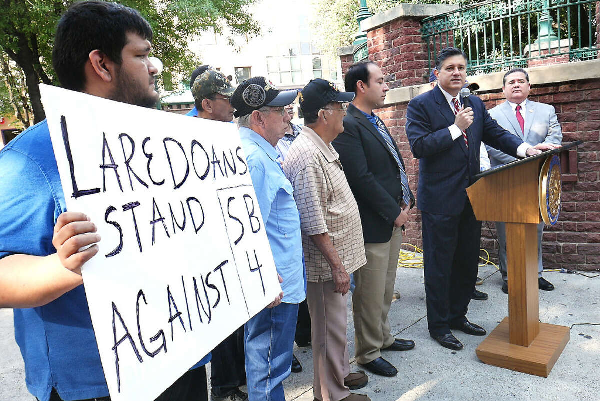Jesus Ochoa holds up a sign, Monday, June 19, 2017, at Jarvis Plaza as he participates in a press conference called by State Representative Richard Peña Paymond to support the El Cenizo/Lulac lawsuit against Senate Bill 4 on Immigration. Joining Rep. Raymond in the event were, Mayor Raul Reyes, members of the City of El Cenizo and Lulac National President Roger Rocha and various Veterans Coalitions.