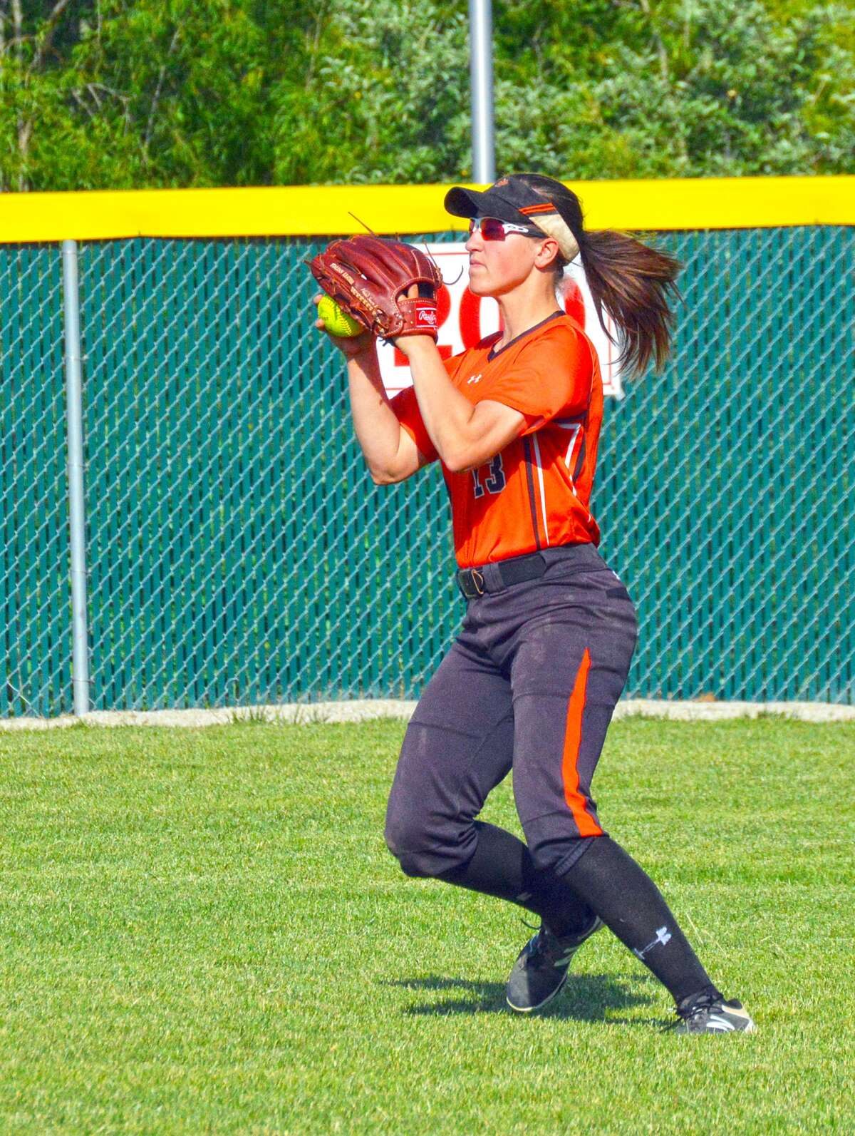 Edwardsville’s Sarah Hangsleben prepares to throw the ball into the infield during a game at Alton.