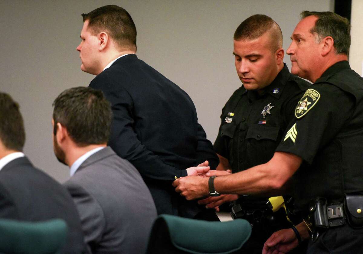 Washington County Sheriff's Officers place handcuffs on Matthew Slocum after he was found guilty on all seven chargers in the triple murder retrial on Tuesday, June 20, 2017, in Washington County Court. (Pool photo/Shawn LaChapelle, The Post-Star)