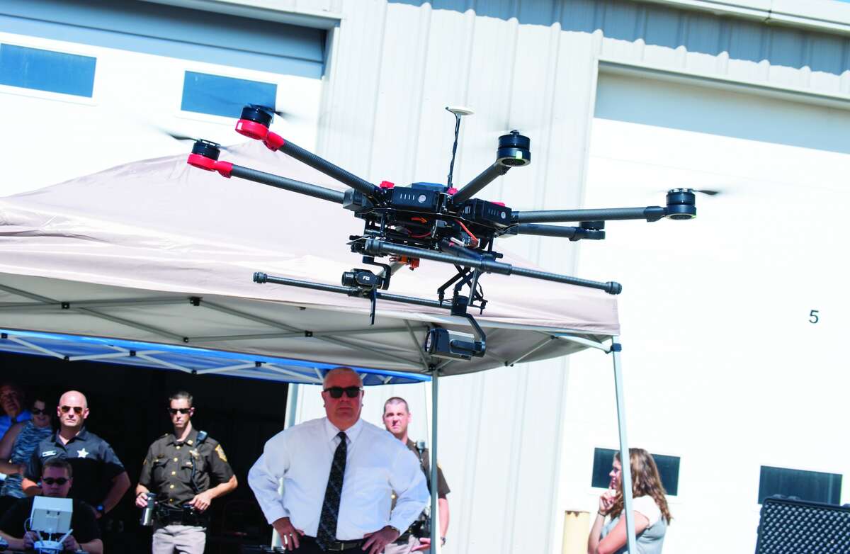 Madison County Sheriff John Lakin, center, watches during Tuesay morning's drone demonstration in at the sheriff's office in downtown Edwardsville.