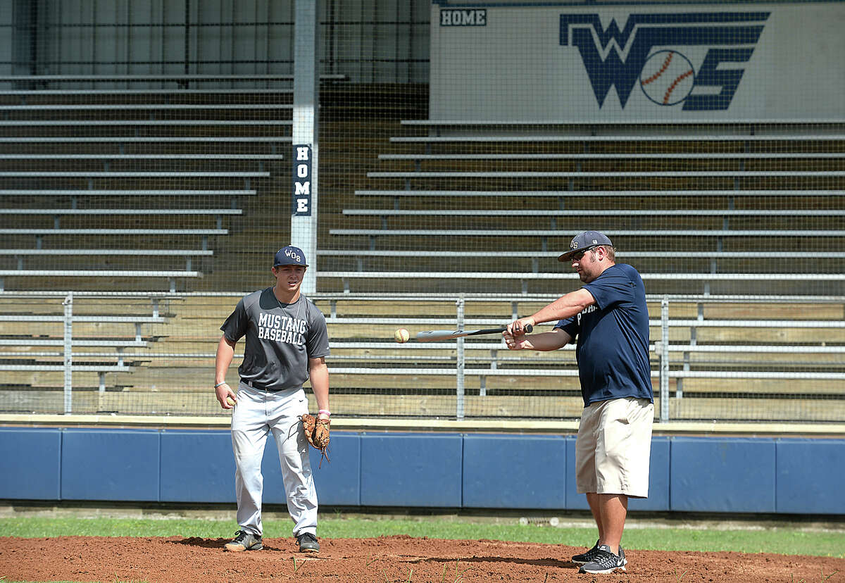 West Orange - Stark's Jack Dallas assists head coach Shea Landry add he bats grounders to the infield during practice after school Tuesday to prepare for their 1 series playoff game Thursday against Waco Robinson. Photo taken Tuesday, May 23, 2017 Kim Brent/The Enterprise