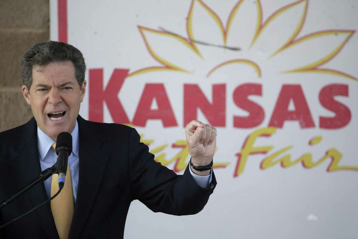 Republican Gov. Sam Brownback participates in a debate at the Kansas State Fair in 2014. A downturn in the state economy is not due to the trickle-down economics the governor favors.