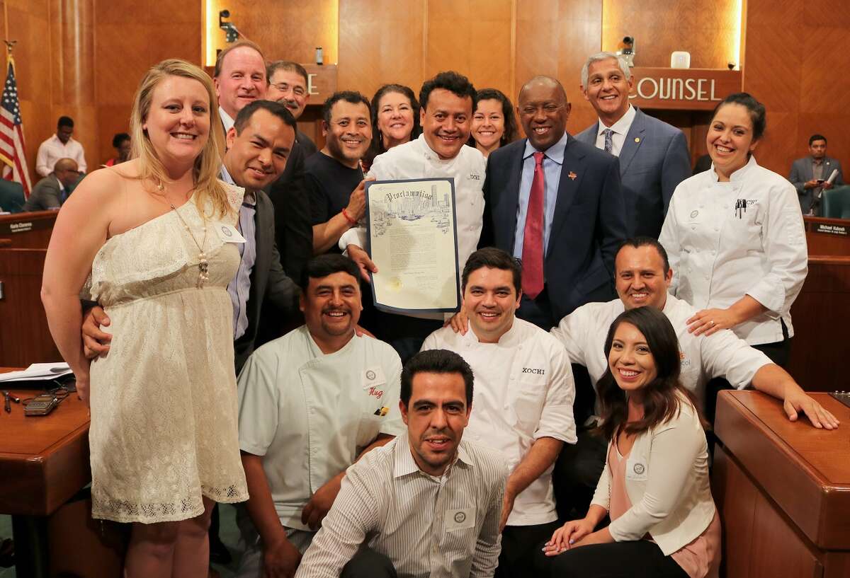 Chef Hugo Ortega receives a proclamation from Mayor Sylvester Turner declaring June 20 Chef Hugo Ortega Day in Houston. Here he is shown with Turner and some of his staff.