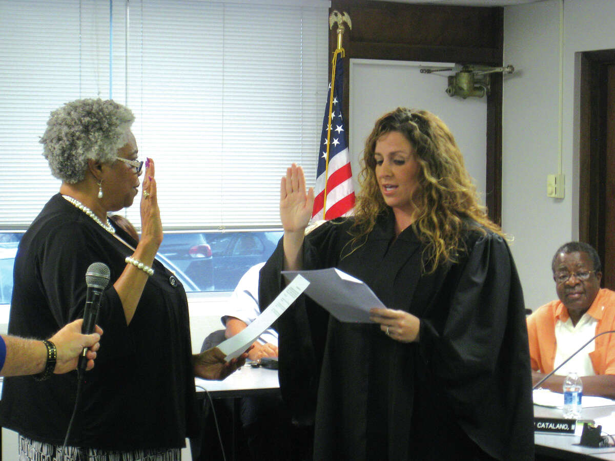 Debra Pitts, left, is sworn in as a member of the Edwardsville District 7 Board of Education by Third Judicial Circuit Judge Sarah Smith at Monday's board meeting at Hadley House.