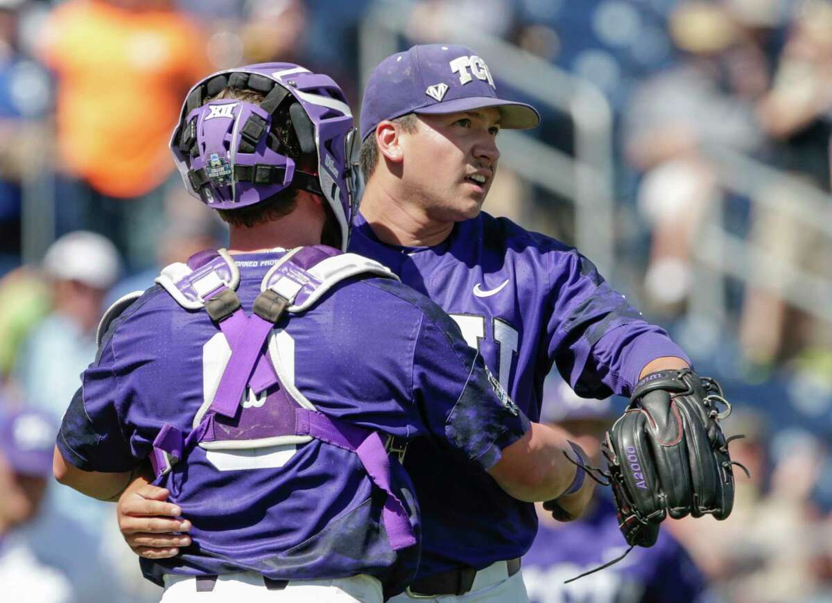 TCU closing pitcher Sean Wymer, right, and catcher Evan Skoug hug after the last out of an NCAA College World Series baseball elimination game against Texas A&M in Omaha, Neb., Tuesday, June 20, 2017. TCU won 4-1, eliminating Texas A&M from the tournament. (AP Photo/Nati Harnik)