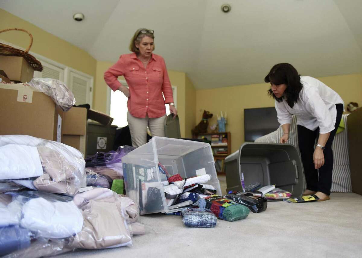 Undies Project Co-Presidents Lucy Langley, left, and Laura Delaflor unpack donated bras and underwear Langley's home in Greenwich, Conn. Tuesday, April 18, 2017. Langley and Delaflor started the Undies Project two years ago and registered as an official nonprofit in November of 2016. The organization has collected and donated about 8,000 new pairs of underwear and new or gently-used bras in that time.