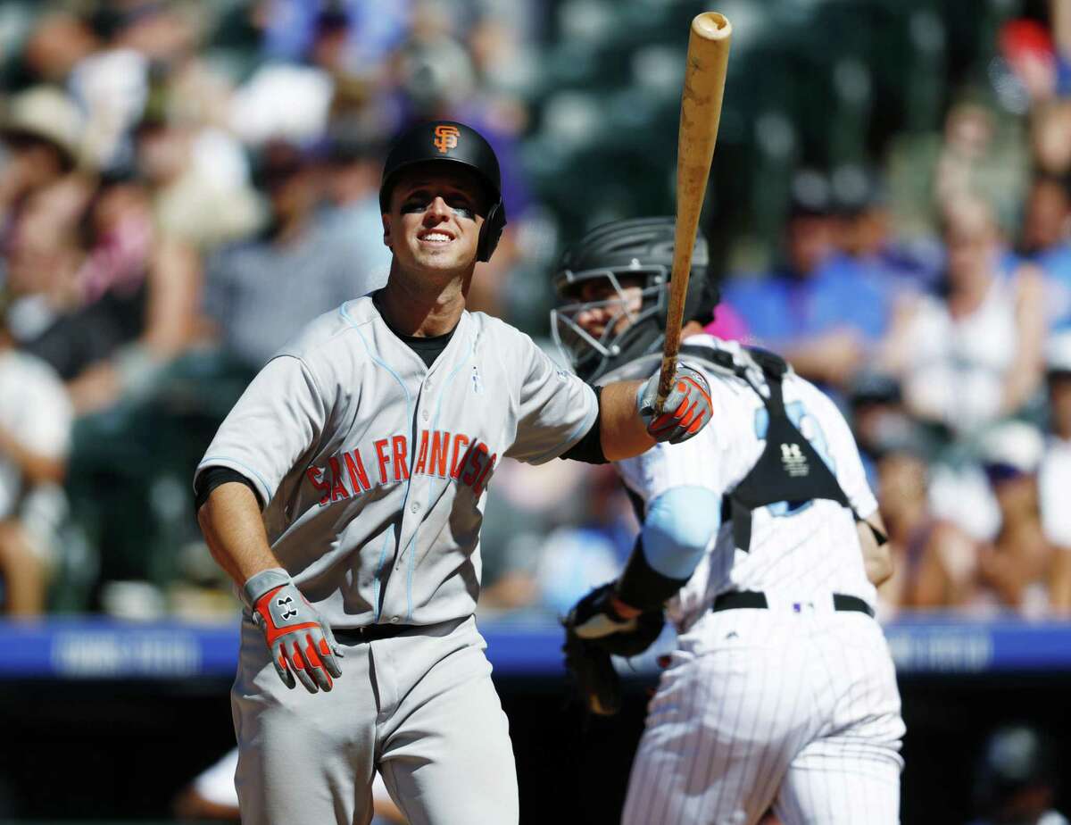 Colorado Rockies' Pat Valaika heads back to the dugout after being