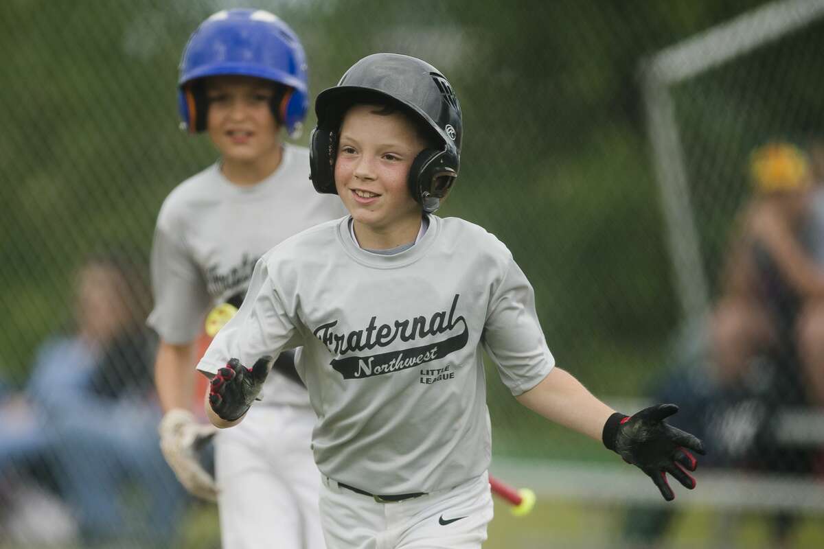 Jackson Larson celebrates a run during his team's 12-2 victory over Sowle Properties during the major Little League city championship game on Tuesday, June 20, 2017 in Midland.