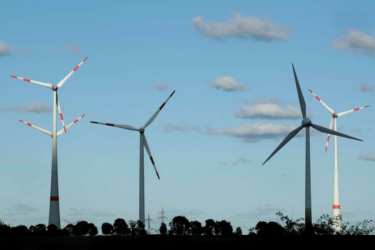 FILE - In this Oct. 4, 2016 file photo wind turbines spin near Leipzig, central Germany, Tuesday, Oct. 4, 2016. World leaders affirmed their commitment Thursday, June 1, 2017 to combating climate change ahead of U.S. President Donald TrumpÂ?’s announcement on whether he would pull out of the Paris climate accord. Trump is expected to announce his decision on Thursday afternoon. (AP Photo/Matthias Schrader,file)