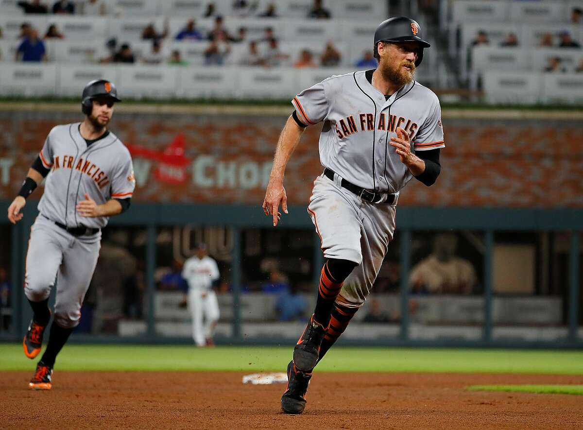 ATLANTA, GA - JUNE 20: Hunter Pence #8 of the San Francisco Giants rounds third base in front of Brandon Belt #9 on a three-run homer hit by Austin Slater #53 in the eighth inning against the Atlanta Braves at SunTrust Park on June 20, 2017 in Atlanta, Georgia. (Photo by Kevin C. Cox/Getty Images)
