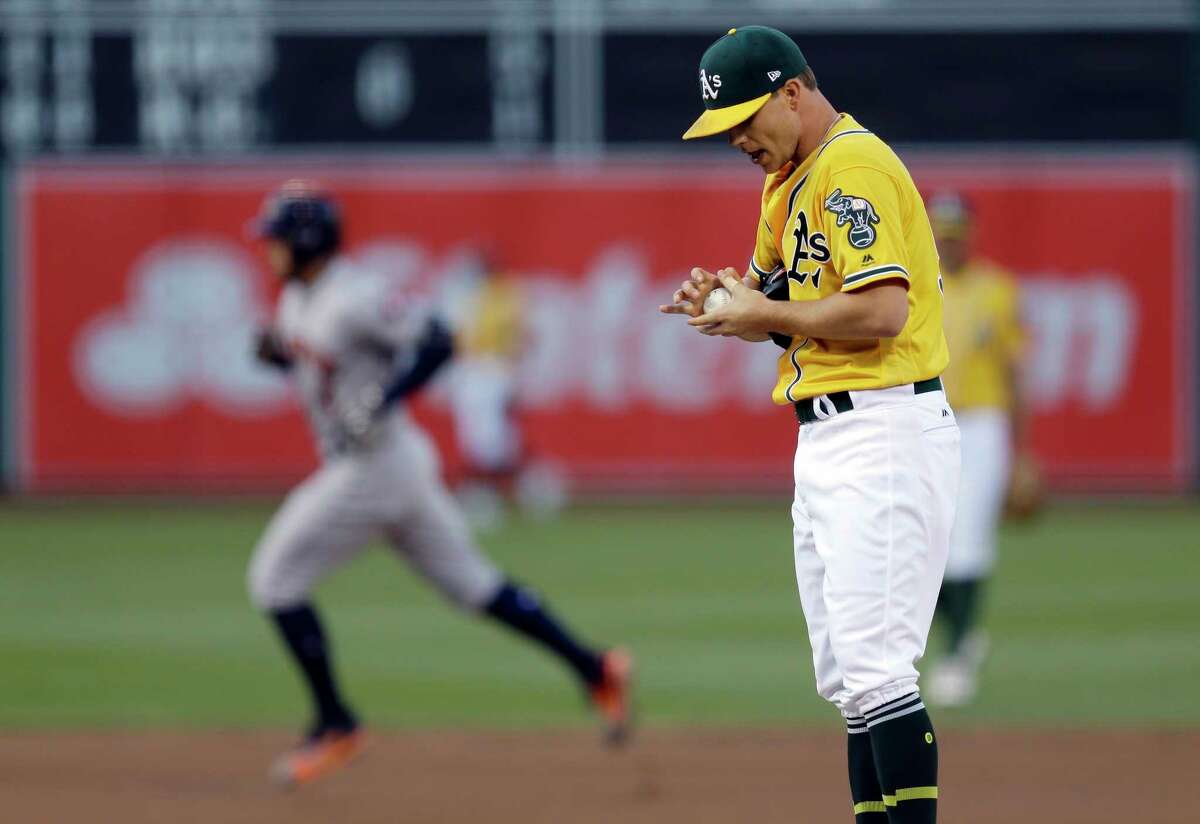 Oakland Athletics pitcher Sonny Gray, right, waits for Houston Astros' George Springer to run the bases after Springer hit a home run during the first inning of a baseball game Tuesday, June 20, 2017, in Oakland, Calif. (AP Photo/Ben Margot)