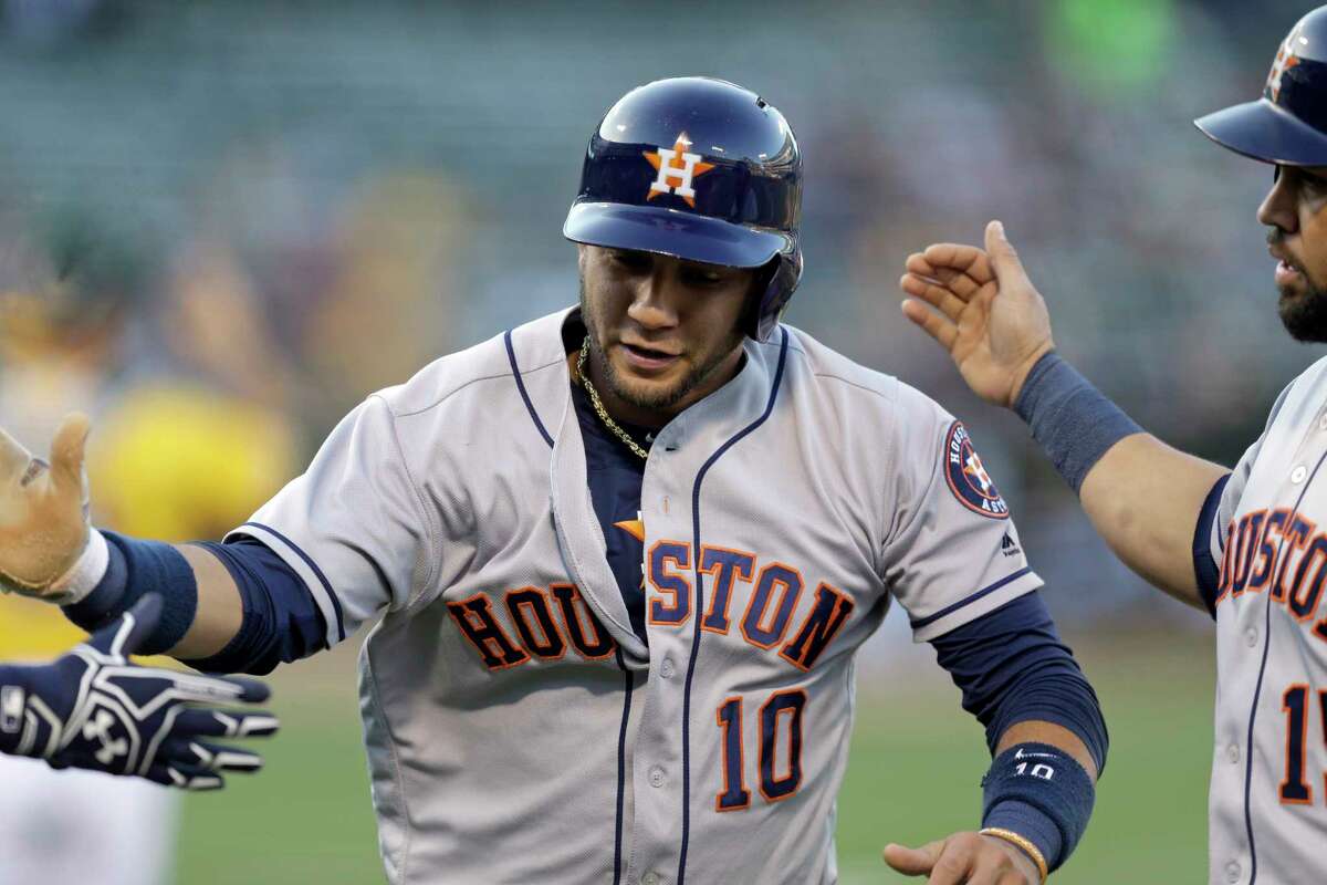 Houston Astros' Yuli Gurriel (10) celebrates with Carlos Beltran, right, and another teammate after scoring against the Oakland Athletics during the first inning of a baseball game Tuesday, June 20, 2017, in Oakland, Calif. (AP Photo/Ben Margot)
