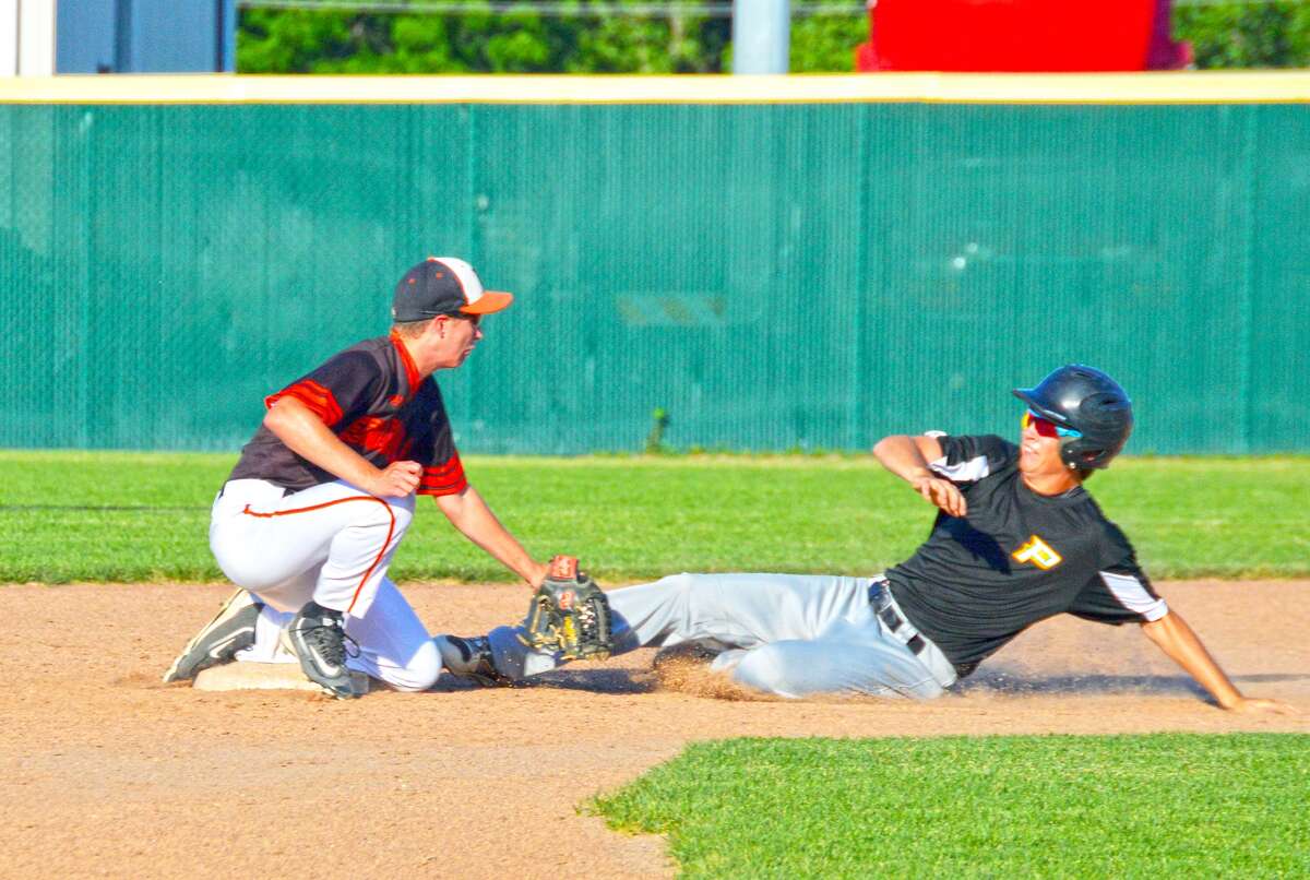 Edwardsville second baseman David Grant, left, tags out a Piasa Southwestern runner trying to stretch a single into a double in the third inning.