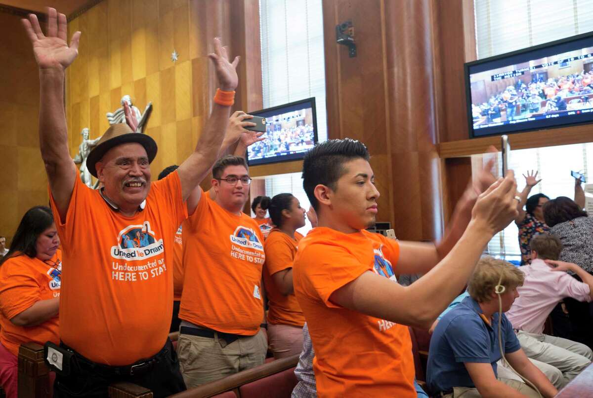 People with United We Dream celebrate after council members voted to join the lawsuit against SB4 during a City Council meeting at City Hall Wednesday, June 21, 2017, in Houston.