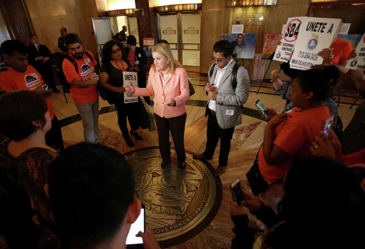 Senator Sylvia Garcia, center, talks to opponents of Senate Bill 4 after Houston council members voted to join the lawsuit against SB4 during a City Council meeting at City Hall Wednesday, June 21, 2017, in Houston.