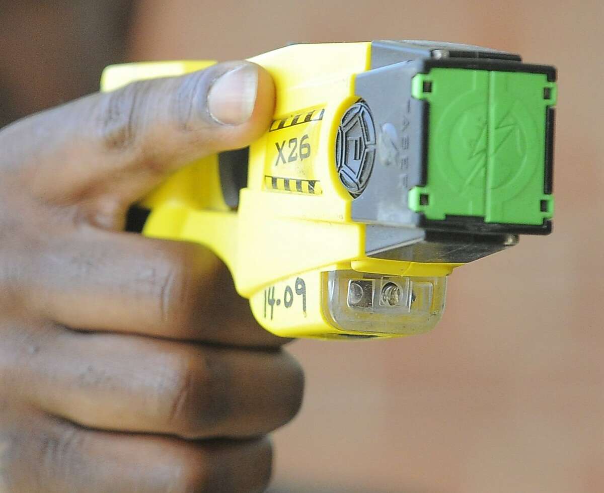 A Stamford Police Officer holds a Taser X26 Stun Gun on April 1, 2016. Blacks and Hispanics are shot with stun guns more often in Connecticut, while whites are given the benefit of a warning far more often, a Hearst review of state data from 2015 shows. Stamford police, however, only shot three people with a stun gun last year.