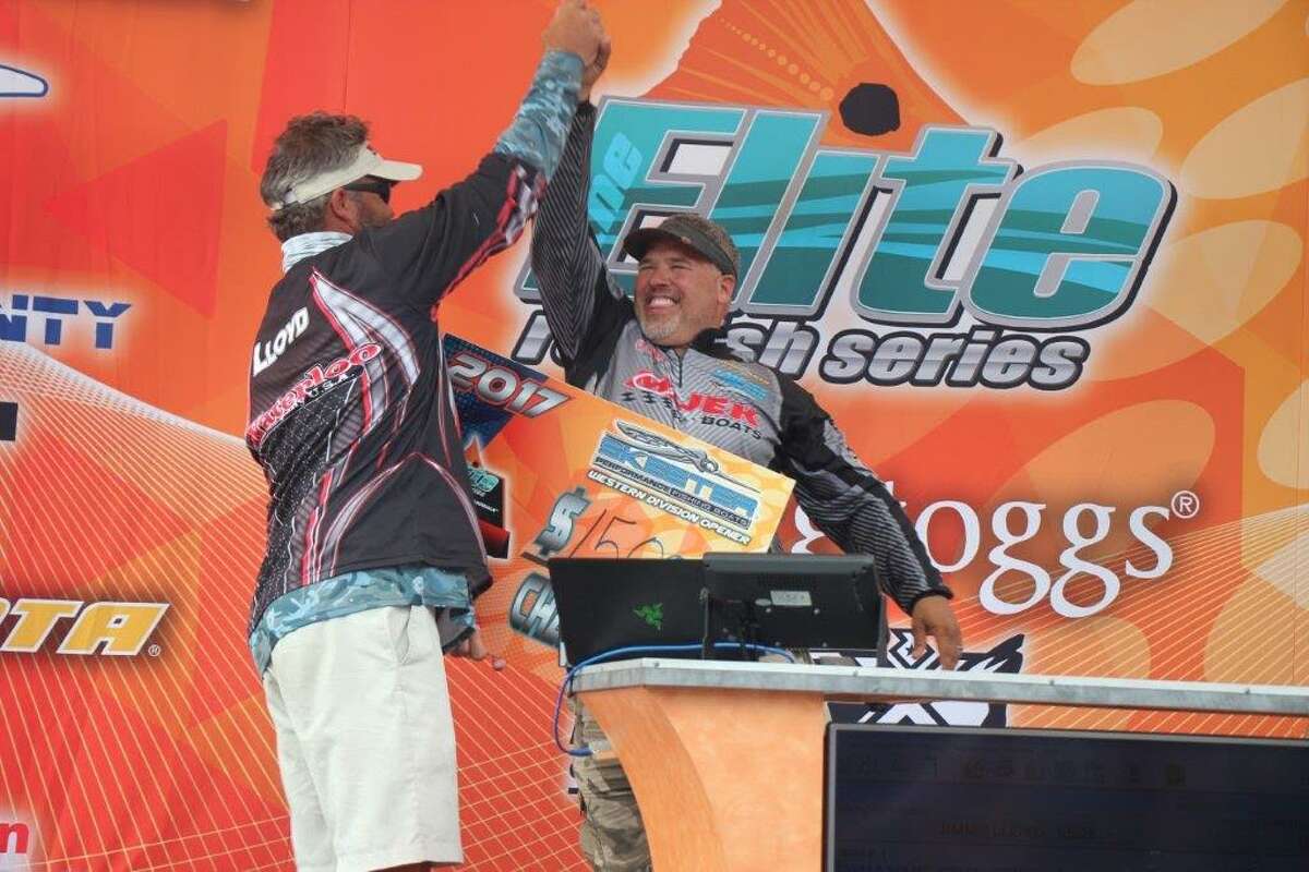 Winning Moment Elite Series Pro Jimmy Loyd, left, congratulates Dwayne Eschete as he takes home a first-place check of $10,000.