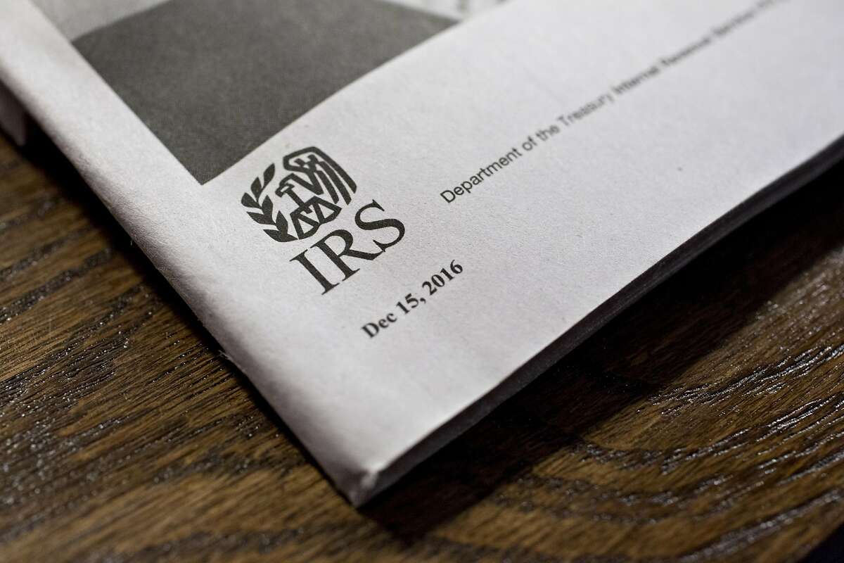 A U.S. Department of the Treasury Internal Revenue Service (IRS) logo is seen on an instruction book for a 1040 Individual Income Tax forms in Tiskilwa, Illinois, U.S., on Tuesday, March 28, 2017. Due to the Emancipation day holiday, this year's income taxes will need to be filed by April 18 instead of April 15. Photographer: Daniel Acker/Bloomberg