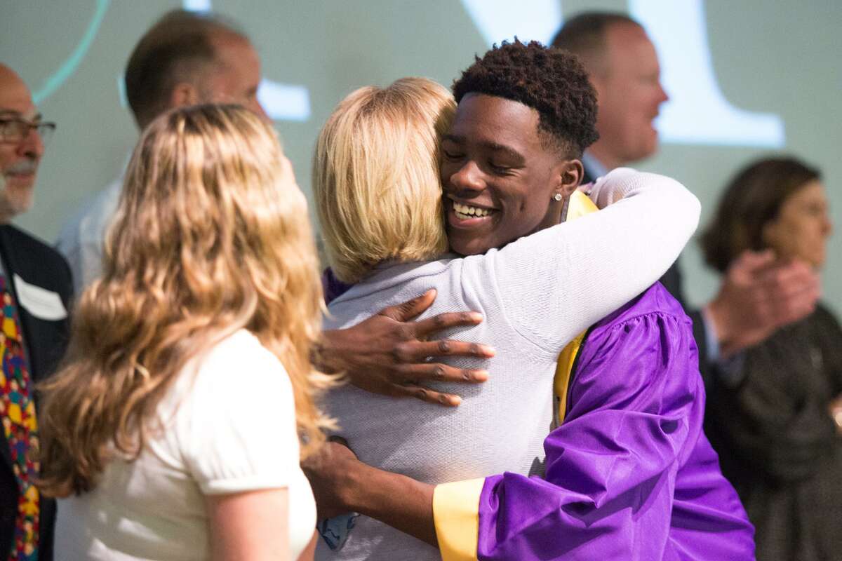 Narold Champagne gives a hug after receiving his scholarship during the 19th Annual Norwalk Housing Foundation Scholarship Awards Ceremony at Stepping Stones Museum for Children in Norwalk on Tuesday, June 20.