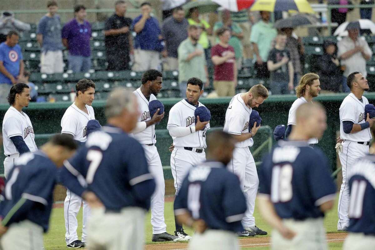 San Antonio players endure a steady rain during the national anthem as the Missions host Northwest Arkansas at Wolff Stadium on April 13, 2017.