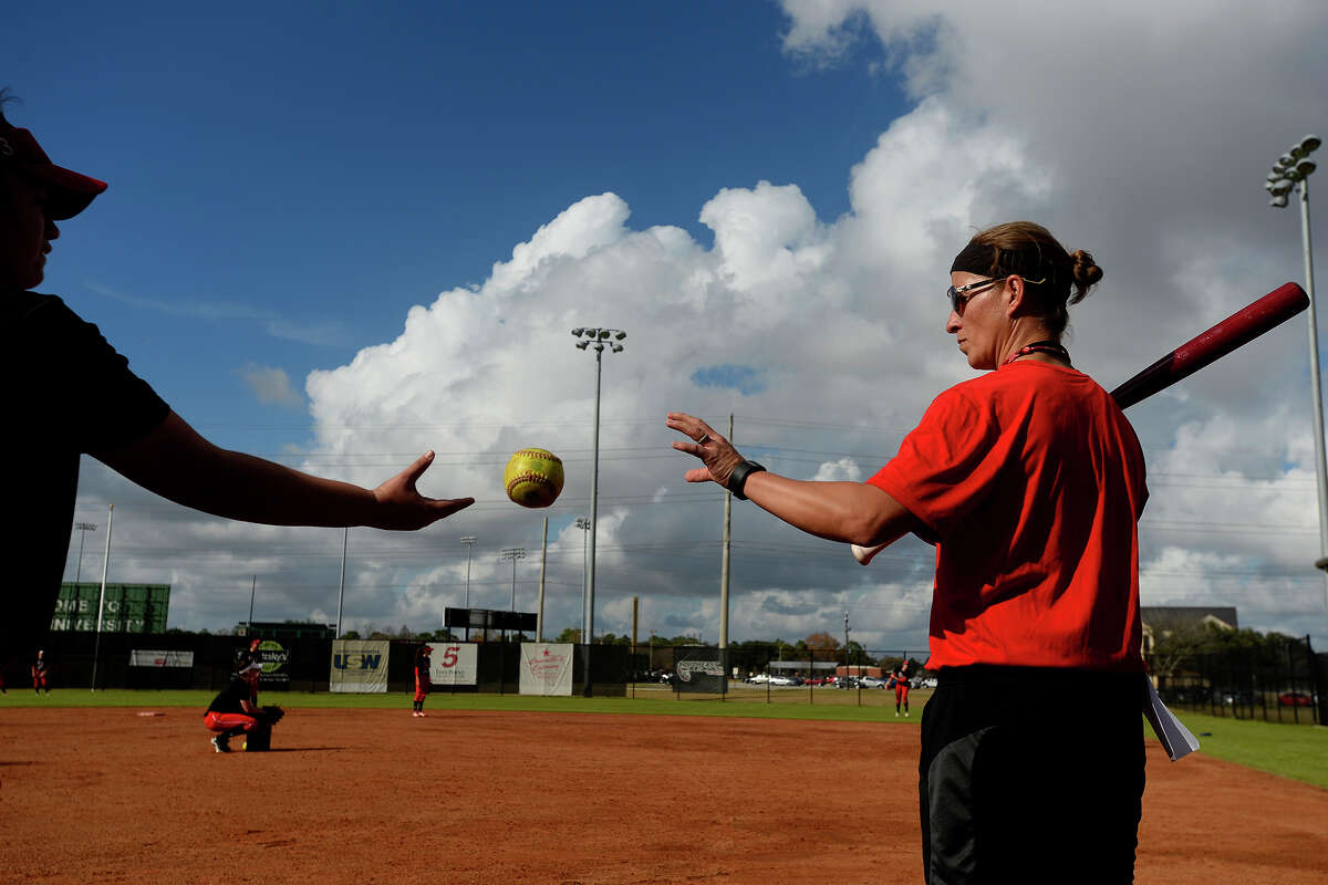 Lamar softball coach Holly Bruder catches a ball to hit ground balls during their first practice of the season on Friday afternoon. The team will play an intrasquad scrimmage Sunday at 1:30 p.m. at the school's softball complex. Last year, the team played in the conference championship, their best year since the program restarted in 2013. Photo taken Friday 1/13/17 Ryan Pelham/The Enterprise
