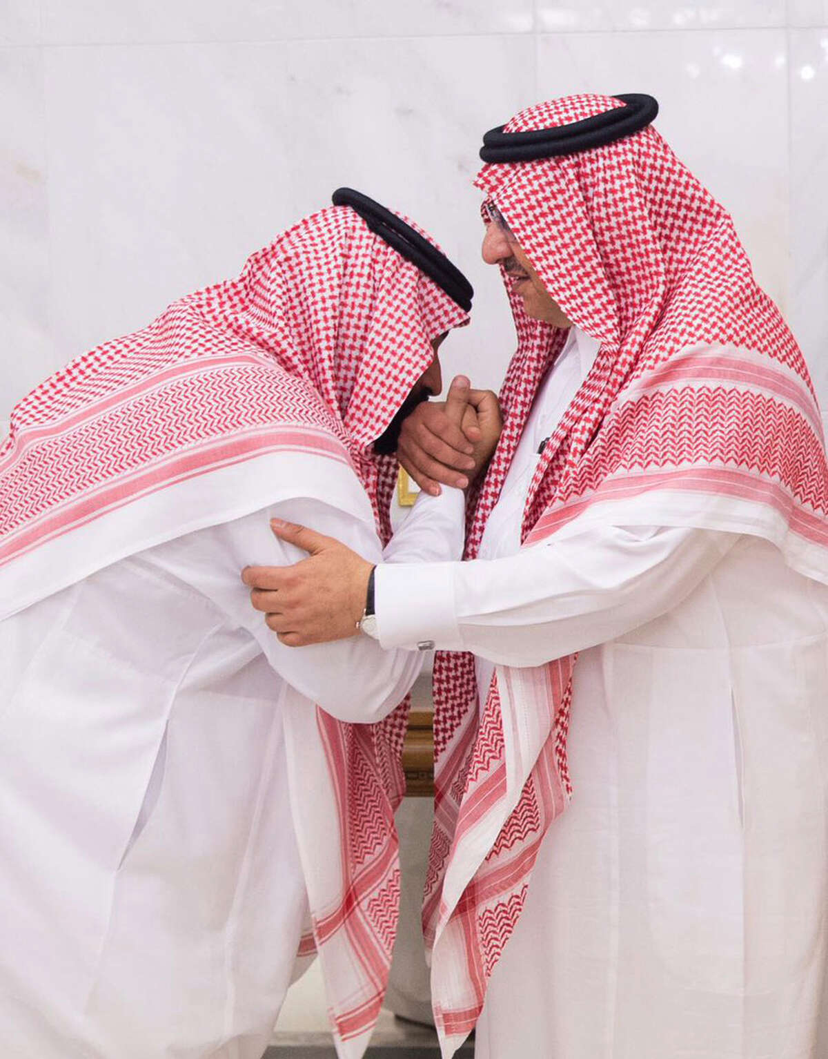 In this Wednesday, June 21 , 2017 photo released by Al-Ekhbariya, Mohammed bin Salman, newly appointed as crown prince, left, kisses the hand of Prince Mohammed bin Nayef at royal palace in Mecca, Saudi Arabia. Saudi Arabia's King Salman on Wednesday appointed his 31-year-old son Mohammed bin Salman as crown prince, placing him first-in-line to the throne and removing the country's counterterrorism czar and a figure well-known to Washington from the line of succession. (Al-Ekhbariya via AP)