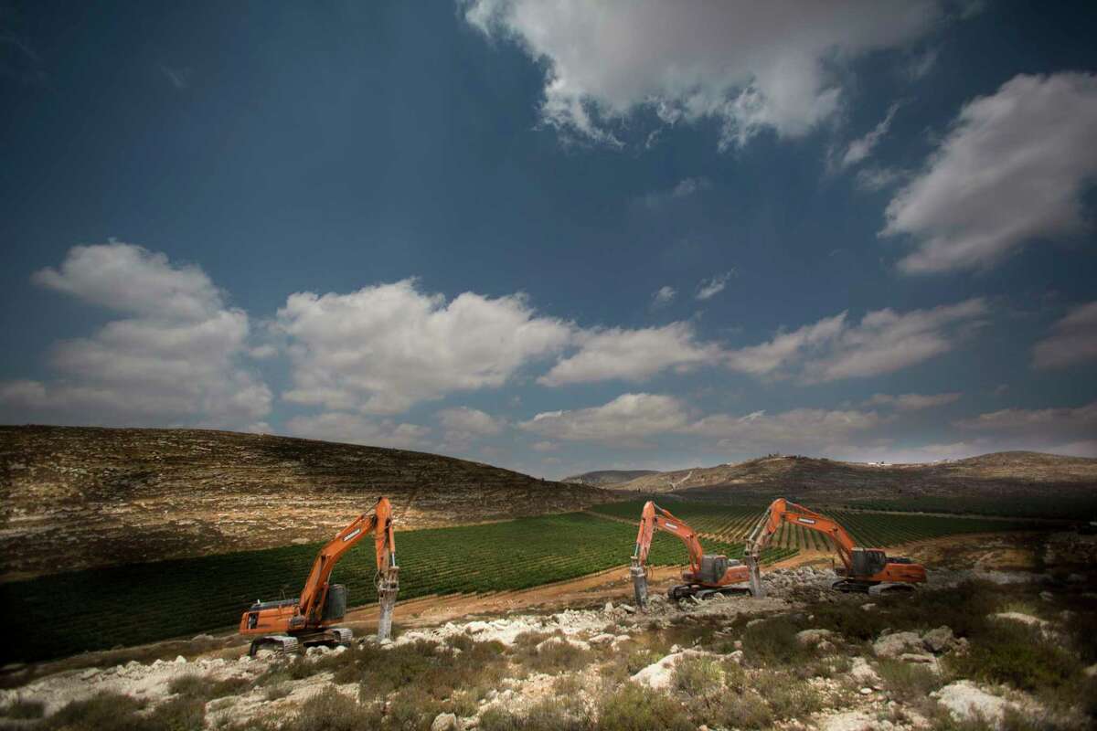 Diggers break the ground for a new settlement near the settlement of Shilo, West Bank, Wednesday, June 21, 2017. Israeli Prime Minister Benjamin Netanyahu said work had begun for the first new Israeli settlement in two decades, to replace Amona, a settlement outpost built on private Palestinian land that was dismantled in February following an Israeli Supreme Court ruling. (AP Photo/Dusan Vranic)