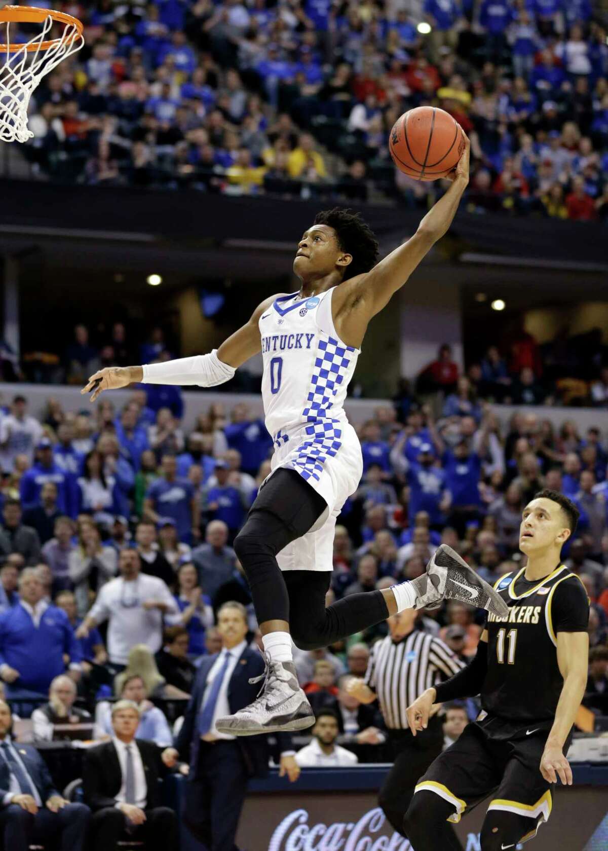FILE - In this March 19, 2017, file photo, Kentucky guard De'Aaron Fox (0) goes up for a dunk in front of Wichita State guard Landry Shamet (11) during the second half of a second-round game in the men's NCAA college basketball tournament, in Indianapolis. Fox is expected to be a picked at the NBA Draft. (AP Photo/Michael Conroy, File)