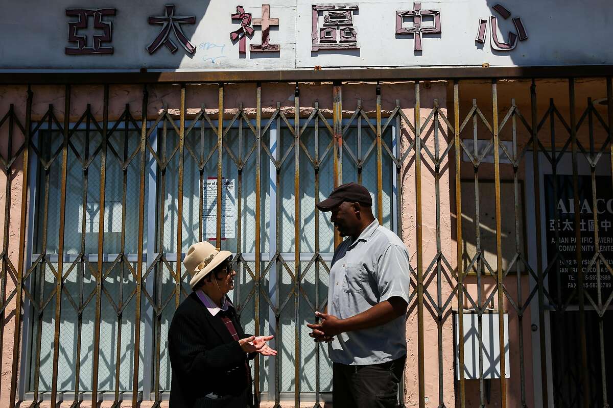 (l-r) Spokeswoman for the Visitation Valley Asian alliance Marlene Tran and community advocate Russel Morine chat as they stand for a portrait outside a building that is being proposed to become a medical marijuana dispensary in San Francisco, California, on Wednesday, June 21, 2017. They are both opposed to the dispensary.