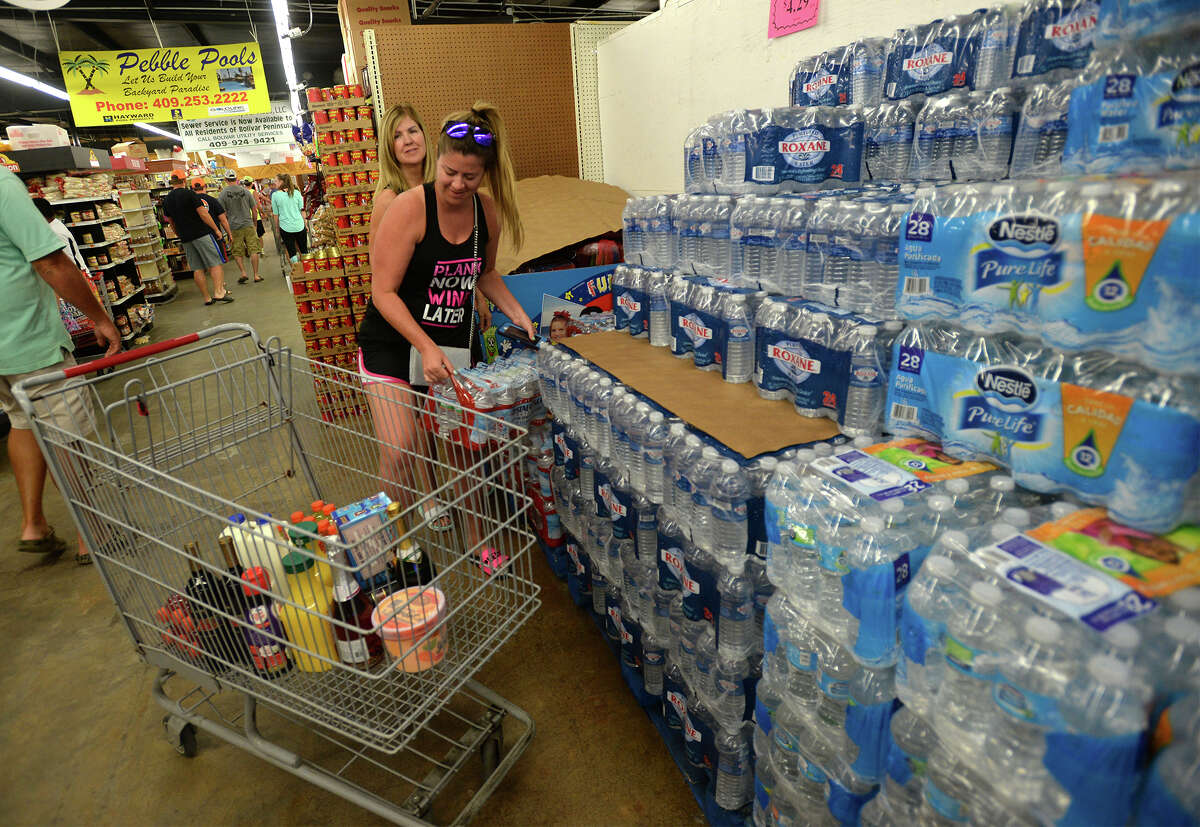 Nicole Cameron and Beverly Allison stock up on supplies Wednesday at The Big Store on Bolivar Peninsula. Though dozens have voluntarily evacuated, many have chosen to ride out Tropical Storm Cindy on the peninsula.